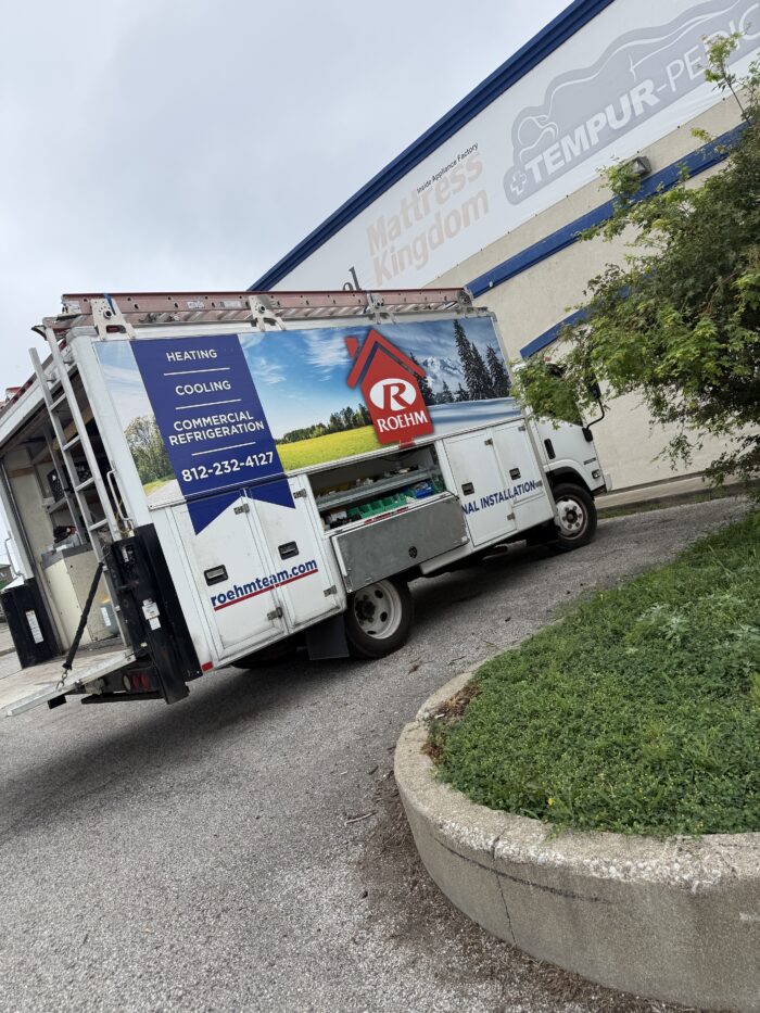 Roehm Truck in driveway of a business on a sunny day.